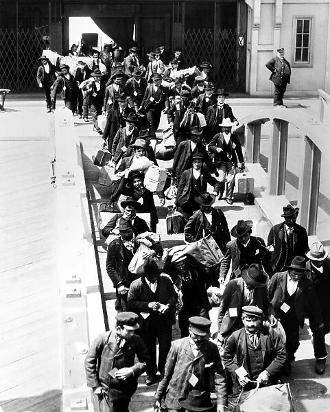 ELLIS ISLAND, c1910. Immigrants arriving at Ellis Island with their belongings