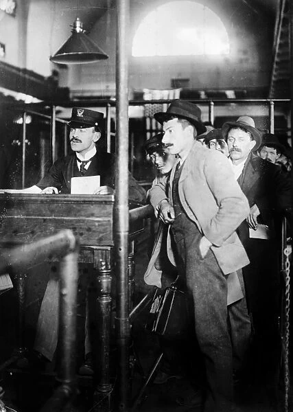 ELLIS ISLAND, c1910. Immigrants waiting to be processed at Ellis Island. Photograph
