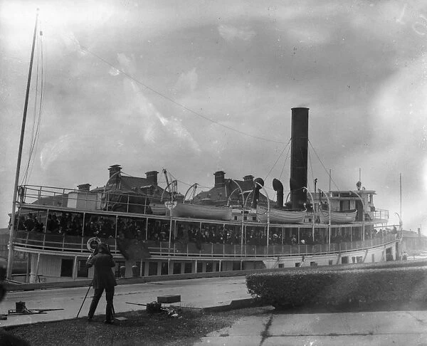 ELLIS ISLAND, c1910. A ship full of immigrants arriving at Ellis Island. Photograph