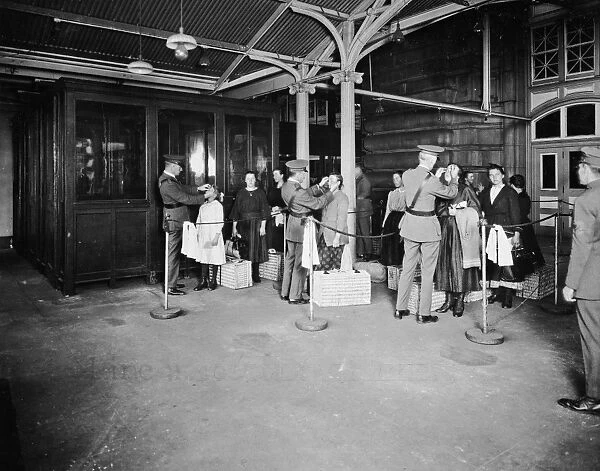 ELLIS ISLAND, c1920. Immigration officials examining the eyes of new immigrants at Ellis Island