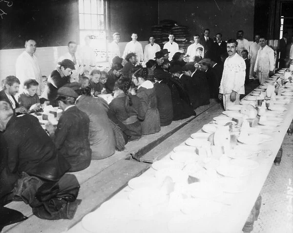 ELLIS ISLAND: DINNER, 1920s. Immigrants being served 25 cent dinners at Ellis Island