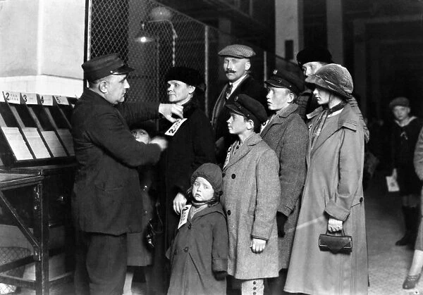 ELLIS ISLAND: TAGGING, 1905. An immigrant family at Ellis Island, New York City