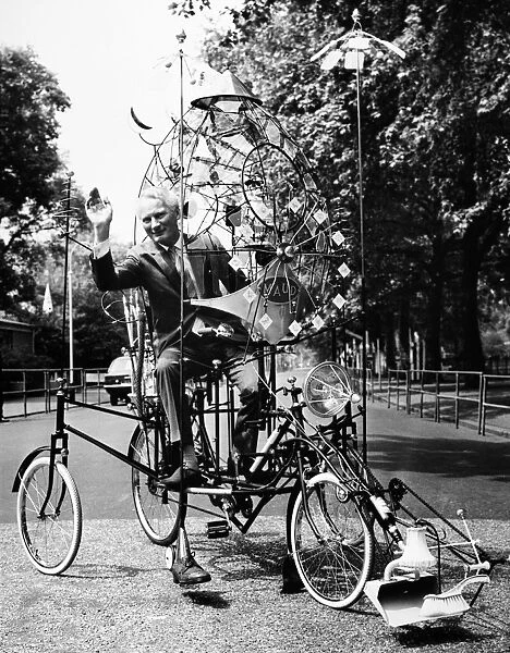 EMETT: LUNACYCLE, 1970. British cartoonist and inventor Rowland Emett, riding his Lunacycle, which he claims can be ridden as a bicycle on Earth and soft landed on the moon. The invention allows space for a cat for companionship and for catching moon mice, a fly-swatter for swatting meteorites away, and a sun shield. Photograph, 1970