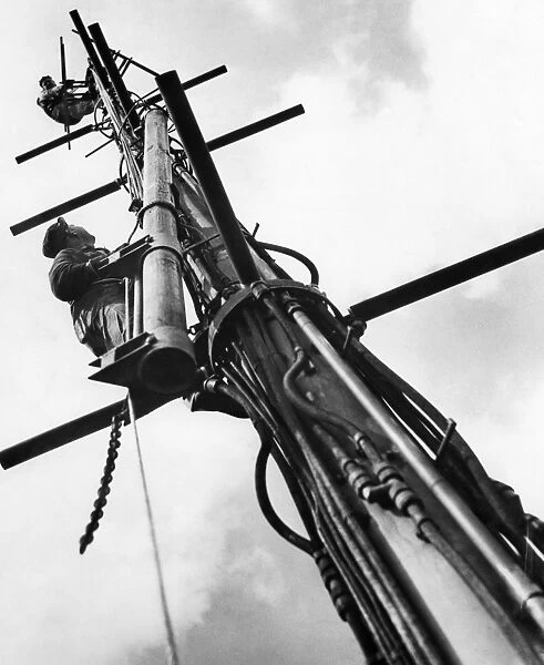 EMPIRE STATE BUILDING, 1947. Riggers installing a lightning rod on top of the Empire