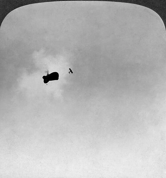 An enemy observation balloon fatally pierced by shell-fire from an American fighter plane. Stereograph, 1917-1918