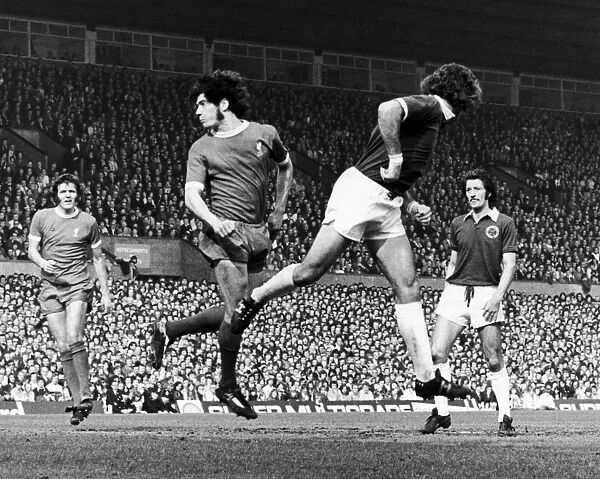 ENGLAND: SOCCER MATCH, 1974. Soccer match between Liverpool Football Club and Leicester Football Club, 30 March 1974. Kevin Keegan of Liverpool (left) beats a Leicester defender to head the ball