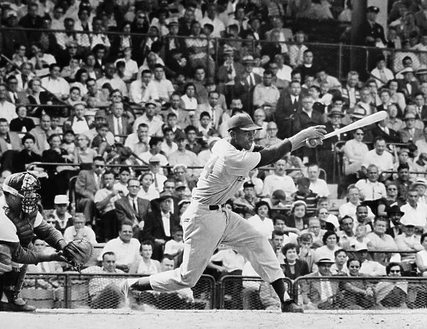 ERNIE BANKS (1931- ). American baseball player. As a member of the Chicago Cubs, batting against the Brooklyn Dodgers in a game at Ebbets Field in Brooklyn, New York, August 1955. The Dodgers catcher is Roy Campanella
