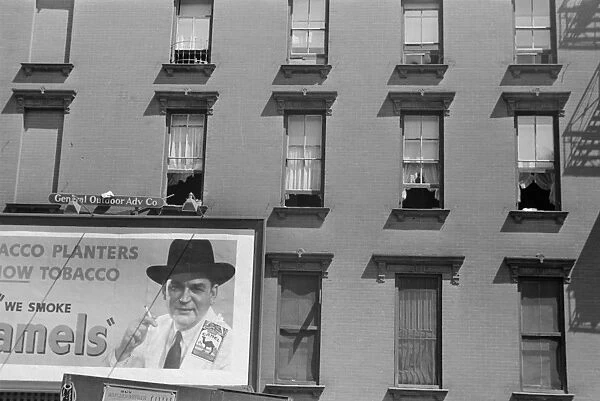 EVANS: NEW YORK, 1938. A billboard on the tenement buildings on 61st Street, between 1st