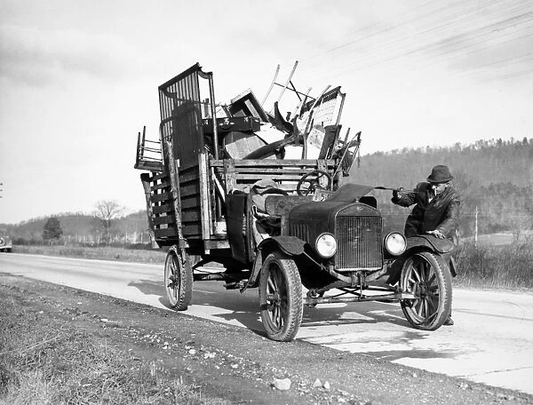 FARMER MOVING, 1937. A tenant farmer moving his household goods to a new farm in Hamilton County