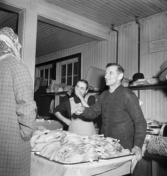 FARMERS MARKET, 1942. Mennonite farmer and wife selling fowl at a farmers market in Lititz