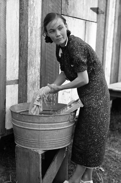 FARMERs WIFE, 1938. A farmers wife washing clothes in a washbin, near Morganza, Louisiana