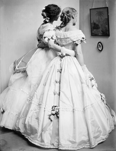FASHION: WOMEN, 1906. Study of the Gerson sisters wearing Crinoline ball gowns