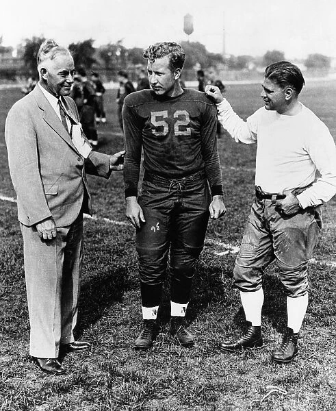 FIELDING YOST (1871-1946). American athletics administrator. Yost (left), as athletic director of the University of Michigan, with football captain Thomas Austin and coach Harry Kipke. Photograph, c1934