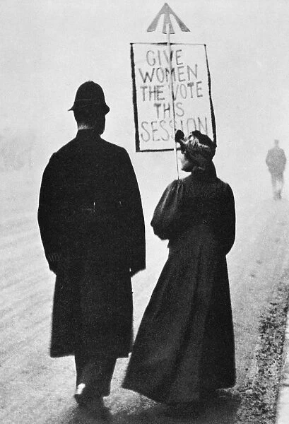 FILM STILL: SUFFRAGETTE. Suffragette and policeman in Whitehall, London, England. Silent film still, 1908