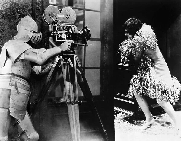 FILM: UNDERWORLD, 1927. Filming a scene for the gangster movie, directed by Joseph von Sternberg in 1927, the cameraman has armored himself against the blast as he films Evelyn Brent fleeing