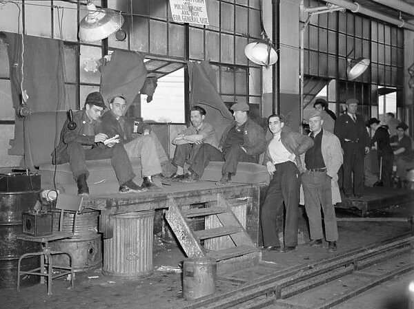 FLINT SIT DOWN STRIKE, 1937. Strikers guarding the entrance to the Fisher body plant #3 in Flint