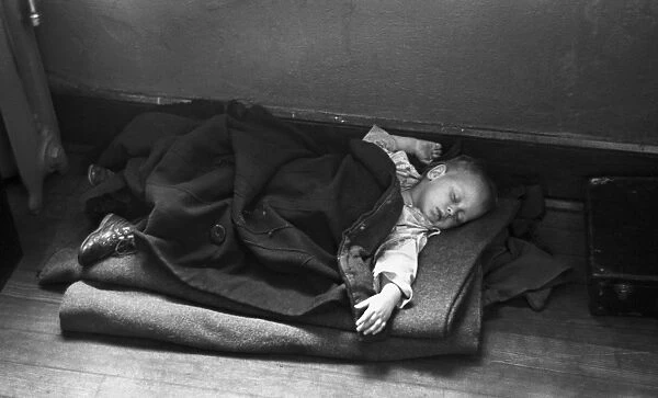 FLOOD REFUGEE, 1937. A young flood refugee sleeping on the floor in a makeshift