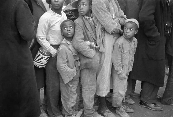 FLOOD REFUGEES, 1937. Boys waiting in a food line at a flood refugee camp in Forrest City