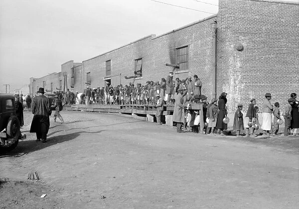 FLOOD REFUGEES, 1937. People waiting in a food line at a flood refugee camp in Forrest City