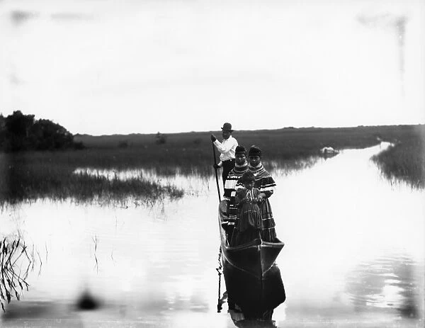 FLORIDA: SEMINOLE CANOE. Seminole Native Americans traveling by canoe in the Florida Everglades
