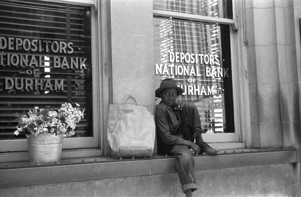 FLOWER VENDOR, 1940. A young African American flower vendor in Durham, North Carolina