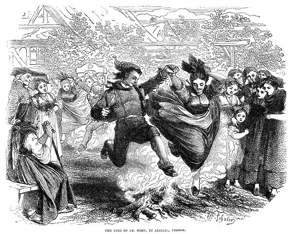 FRANCE: ST. JOHNs DAY, 1867. Villagers dancing around bonfires in Alsatia, France