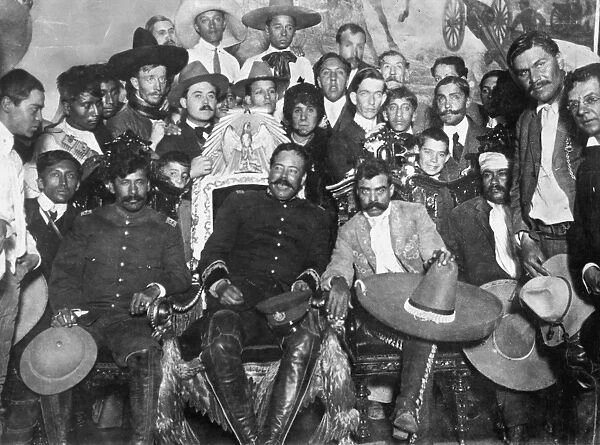 FRANCISCO PANCHO VILLA (1877-1923). Mexican revolutionary leader. Villa (center) and Emiliano Zapata (next to Villa, right, with sombrero on knee) in the Presidential Palace at Mexico City. Photograph, 1914, by Agustin Casasola