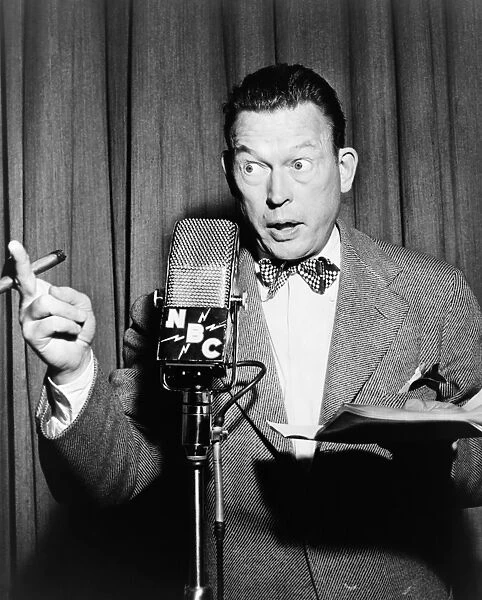 FRED ALLEN (1894-1956). American comedian and actor. Performing into a NBC microphone