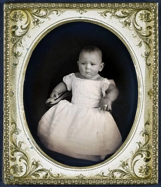 Full-length portrait of an unidentified child. Daguerreotype, c1855, with brass frame