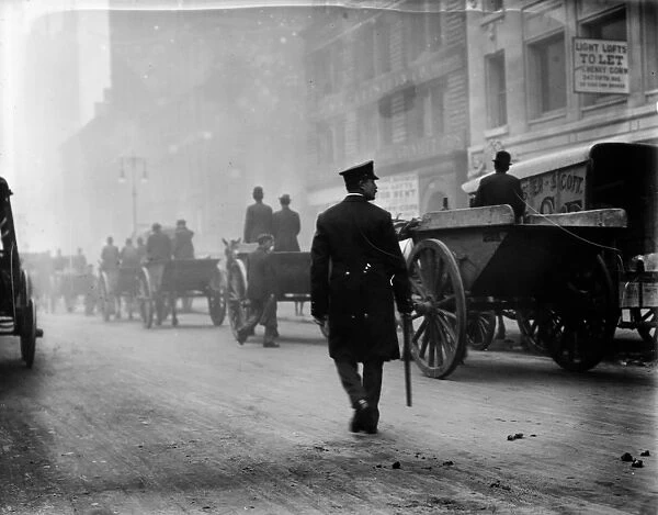GARBAGE STRIKE, 1911. Police protecting garbage carts during a garbage strike in New York City
