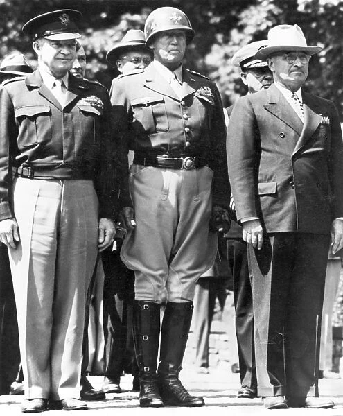 General Dwight D. Eisenhower, General George S. Patton, and President Harry S. Truman watching as the American flag is raised at Berlin, July 1945, the same flag that had flown over the U. S. Capitol in December 1941 when the U. S. Congress declared war on the Axis powers
