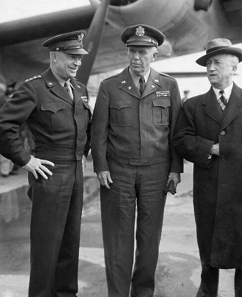 General Dwight D. Eisenhower (left) greets General George C. Marshall, U. S. Army Chief of Staff, and Director of War Mobilization James F. Byrnes on their arrival aboard the first ATC transport to fly directly to France from America, 6 October 1944