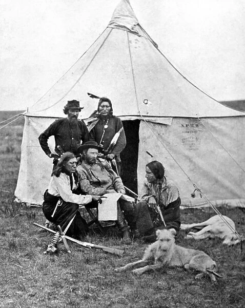 GEORGE ARMSTRONG CUSTER (1839-1876). American army officer. Photographed with scouts during the Yellowstone Expedition, 1873