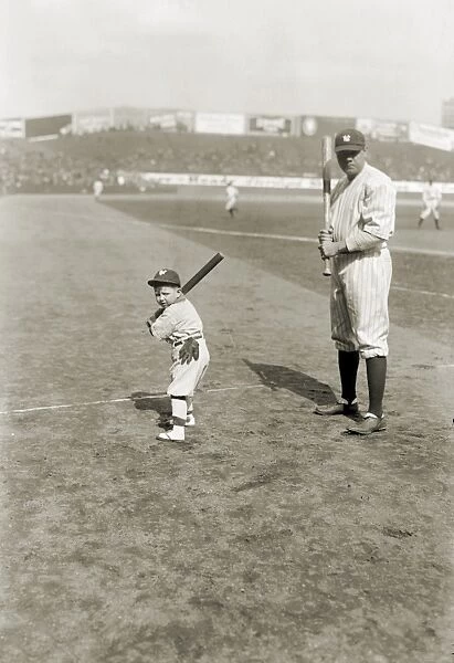 GEORGE H. RUTH (1895-1948). Known as Babe Ruth. American professional baseball player. Posing with a young boy, while playing with the New York Yankees, 1922
