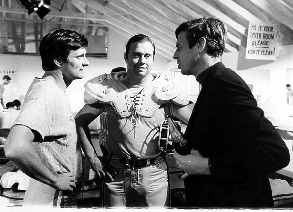 GEORGE PLIMPTON (1927-2003). American writer and editor. Plimpton (far right) with John Gordy (center), Detroit Lions guard, and Alan Alda during the filming of Paper Lion, based on Plimptons book. Photographed 12 March 1968