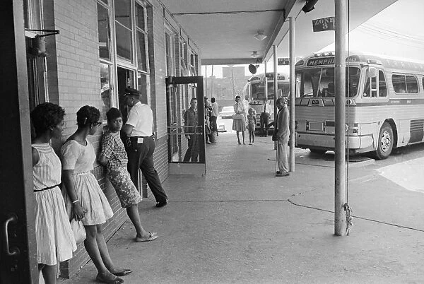 GEORGIA: BUS STATION, 1962. Passengers waiting outside of a Trailways bus station in Albany