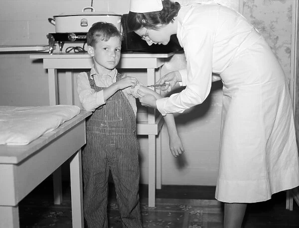 GEORGIA: HEALTH CLINIC. A boy being inoculated for typhoid in a clinic at Irwinville Farms