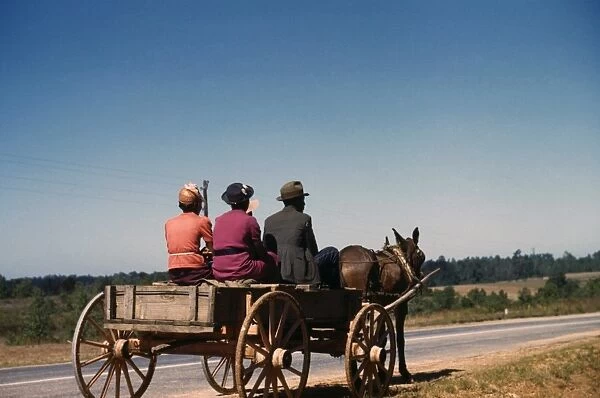 GEORGIA: TRAVEL, 1941. Three African Americans traveling to town in a horse drawn