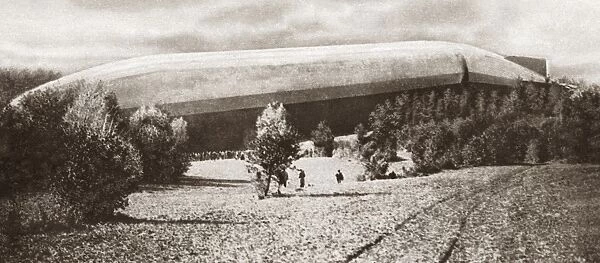 German Zeppelin airship lying helpless in a field near Bourbonne-les-Bains, France, during World War I. Photograph, c1916