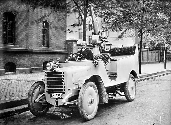 GERMANY: ARMED CAR. German automobile with a cannon in the back