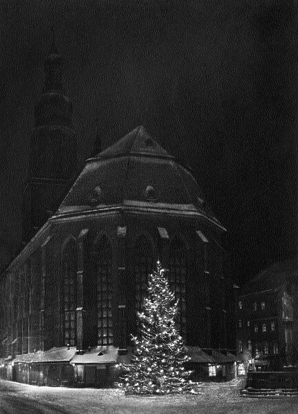 GERMANY: HEIDELBERG, c1920. Christmas tree in front of the Church of the Holy Spirit