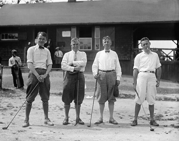 GOLF: MEN, 1924. Men wearing golf clothing and holding golf clubs. Photograph, 1924