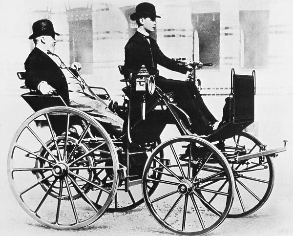 GOTTLIEB DAIMLER (1834-1900). German engineer and pioneer automobile manufacturer. Gottlieb Daimler, at left, enjoying a ride in the first automobile he manufactured and which is here driven by his son Adolf, in 1886