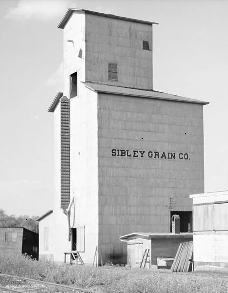 GRAIN ELEVATOR, 1936. A grain elevator near Gibson City, Illinois. Photograph by Carl Mydans