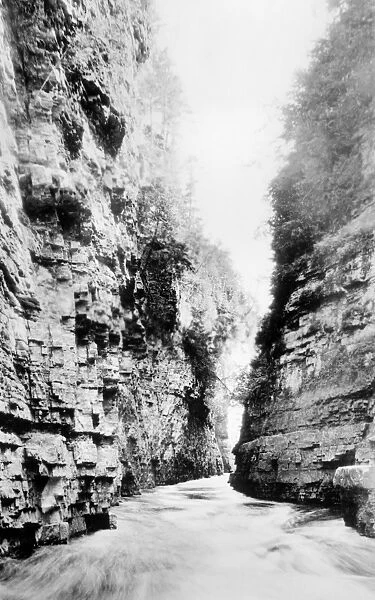 GRAND CANYON, c1920. A view of the Colorado River flowing through a gorge in the