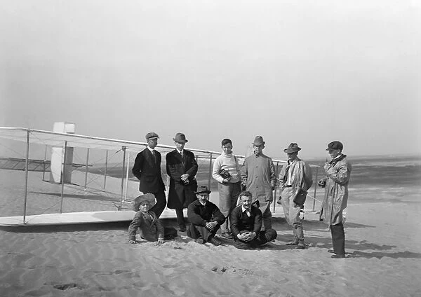 Group portrait in front of the Wright glider at Kill Devil Hill. Sitting: Horace Wright, Orville Wright, and Alexander Ogilvie, standing: Lorin Wright, and group of journalists at Kitty Hawk, North Carolina. Photograph, 1911