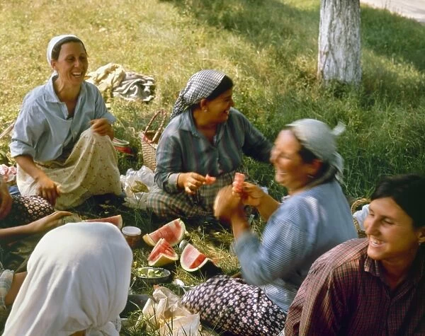A group of tomato pickers enjoying watermelon near Popina, northern Bulgaria. Photographed c1970