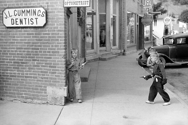 GUN FIGHT, 1939. Boys having a toy gun fight in Boscobel, Wisconsin. Photograph by John Vachon