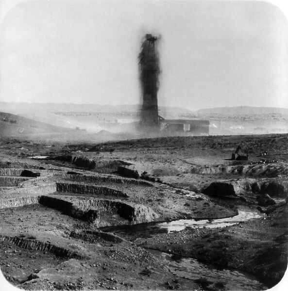 Gushing oil well and a stream of oil in the foreground, Kirkuk, Iraq, 1932-33