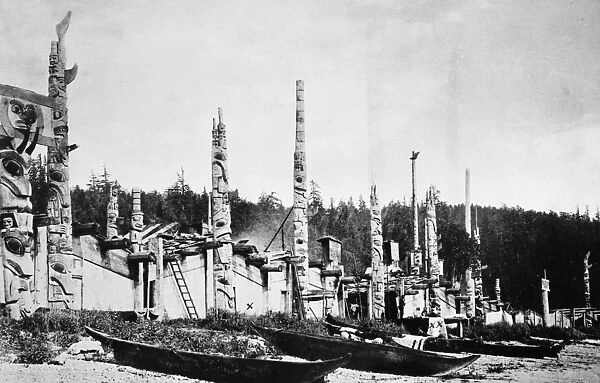 HAIDA VILLAGE, 1878. Totem poles and canoes in the Haida village of Skidegate in